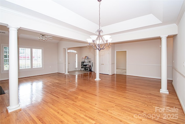 unfurnished living room with light wood finished floors, a raised ceiling, decorative columns, and a ceiling fan