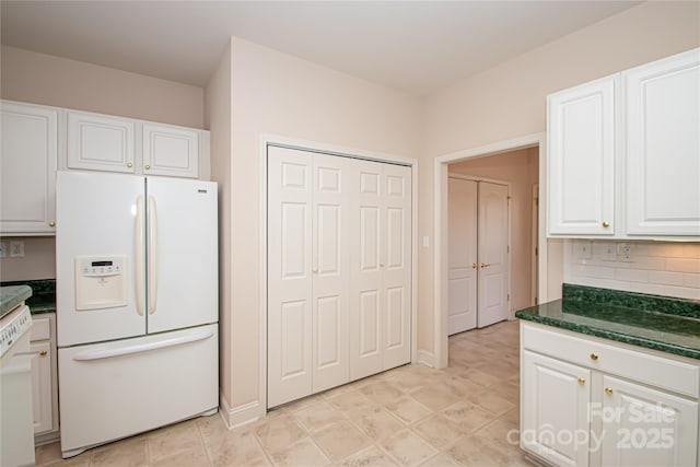 kitchen with white fridge with ice dispenser, white cabinetry, and decorative backsplash