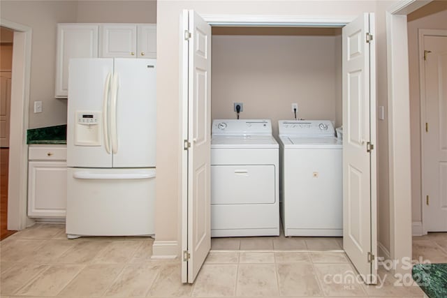 washroom featuring laundry area, independent washer and dryer, and light tile patterned flooring