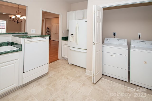 laundry room with light tile patterned floors, laundry area, a sink, independent washer and dryer, and an inviting chandelier