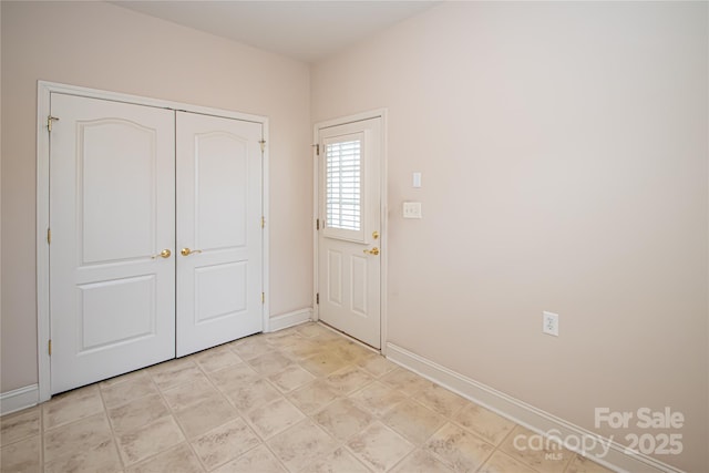 interior space featuring baseboards