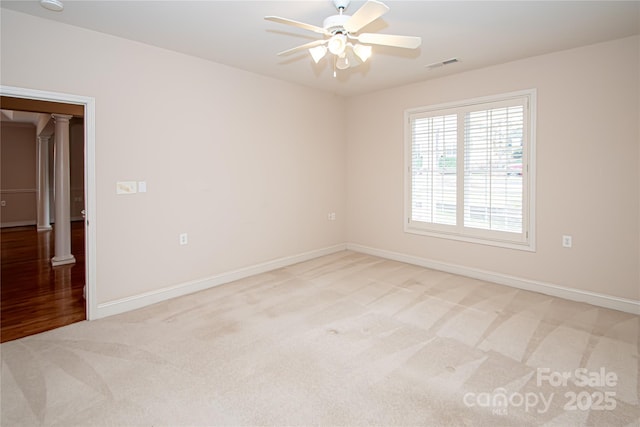 empty room with a ceiling fan, carpet, visible vents, and baseboards