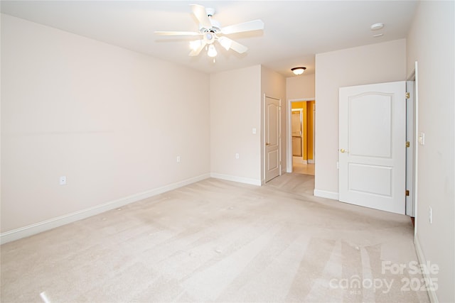 unfurnished room featuring ceiling fan, baseboards, and light colored carpet