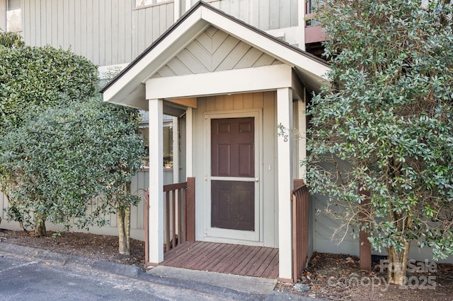 property entrance featuring board and batten siding