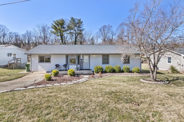 single story home featuring driveway, a porch, and a front yard