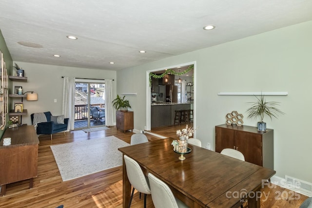 dining space with recessed lighting, visible vents, baseboards, and wood finished floors