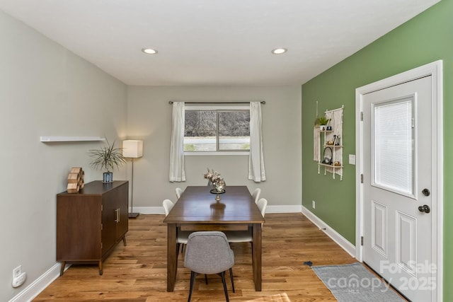 dining area featuring light wood finished floors, baseboards, and recessed lighting