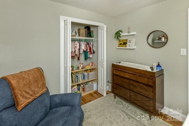 sitting room with wood finished floors and baseboards