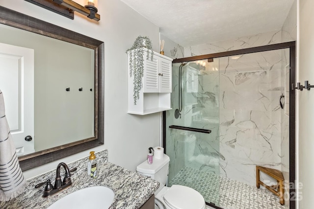 bathroom with toilet, vanity, and a marble finish shower