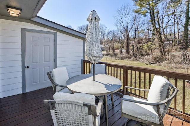 wooden terrace with outdoor dining area