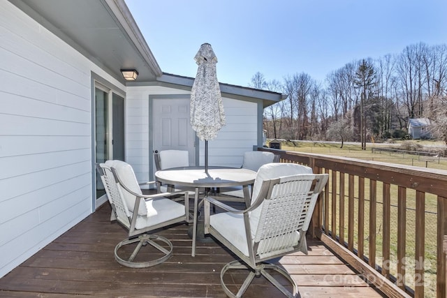 wooden terrace featuring outdoor dining space