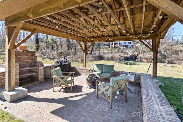 view of patio / terrace featuring a gazebo, fence, area for grilling, and an outdoor living space with a fire pit