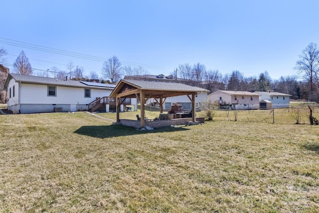 view of yard with fence, stairway, and a gazebo