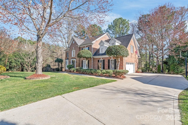 view of front facade with a garage, driveway, a front lawn, and brick siding