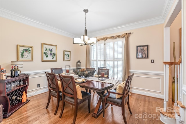 5101 Belicourt Dr, Charlotte, NC 28277 - dining room featuring a chandelier, ornamental molding, wainscoting, and light wood-style flooring