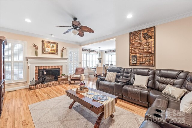 5101 Belicourt Dr, Charlotte, NC 28277 - living area with a brick fireplace, ceiling fan, crown molding, light wood-style floors, and recessed lighting