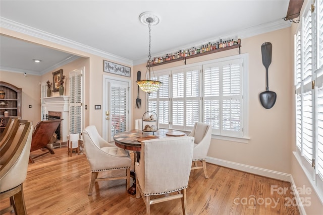 5101 Belicourt Dr, Charlotte, NC 28277 - dining space with light wood-type flooring, a fireplace, and crown molding