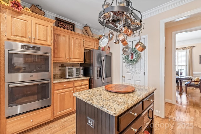 5101 Belicourt Dr, Charlotte, NC 28277 - kitchen with light wood finished floors, a toaster, stainless steel appliances, and crown molding
