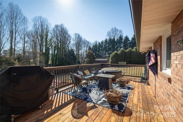 wooden terrace featuring a grill