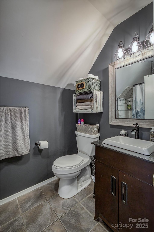 full bathroom featuring baseboards, vaulted ceiling, vanity, and toilet