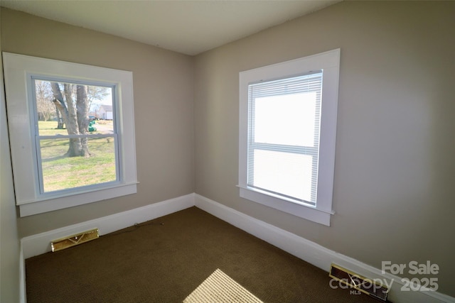 spare room with carpet floors and baseboards