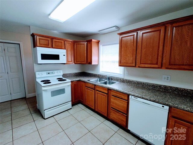 1806 Bringle Ferry Rd, Salisbury, NC 28146 - kitchen featuring dark countertops, white appliances, a sink, and light tile patterned flooring