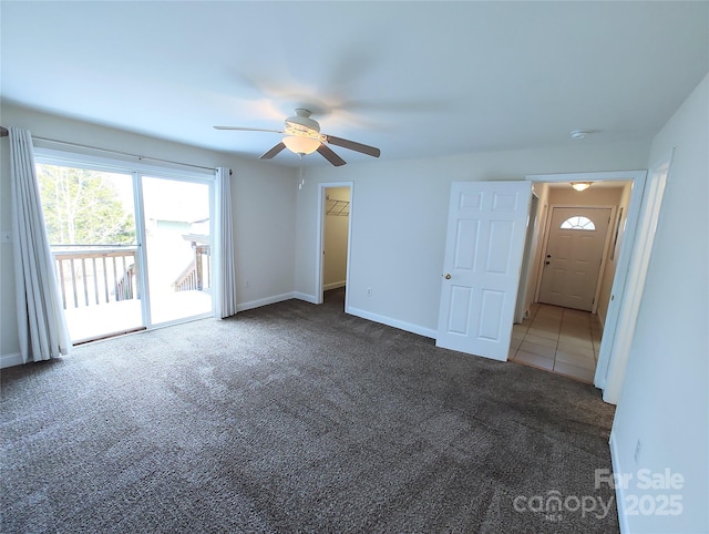 1806 Bringle Ferry Rd, Salisbury, NC 28146 - interior space with a ceiling fan, baseboards, access to exterior, dark carpet, and a walk in closet