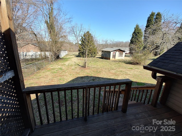 1806 Bringle Ferry Rd, Salisbury, NC 28146 - deck featuring a fenced backyard, a storage unit, a lawn, and an outbuilding