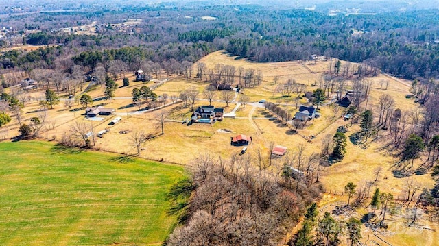 drone / aerial view featuring a wooded view and a rural view