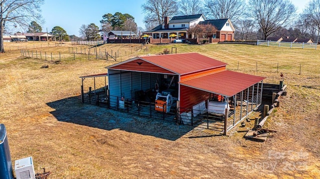 view of outbuilding featuring dirt driveway, an outdoor structure, and an exterior structure