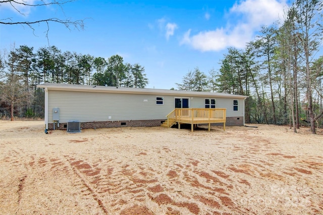 back of house featuring central AC, crawl space, and a wooden deck