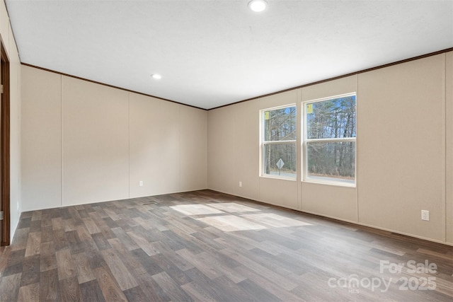 unfurnished room featuring crown molding, wood finished floors, and recessed lighting