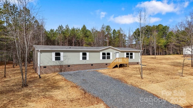 manufactured / mobile home with crawl space and gravel driveway