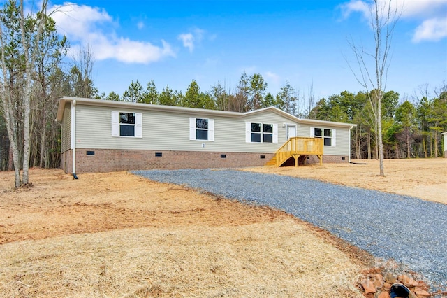 manufactured / mobile home featuring crawl space, driveway, and stairway