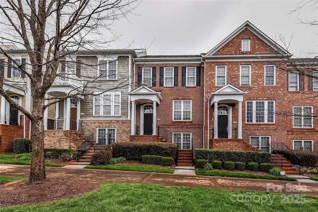 townhome / multi-family property featuring brick siding