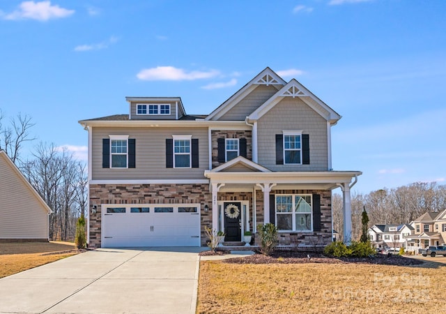 craftsman house with concrete driveway, covered porch, an attached garage, stone siding, and a front lawn