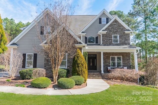 craftsman house with stone siding and a porch