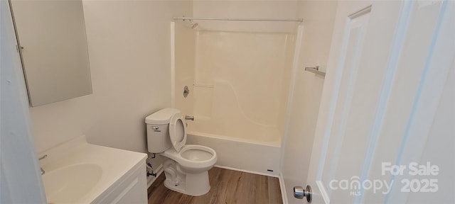 full bath featuring toilet, vanity, wood finished floors, and shower / bathing tub combination