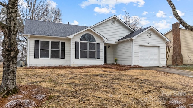 single story home with a garage, cooling unit, concrete driveway, and roof with shingles