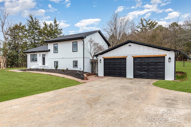 tri-level home with driveway, roof with shingles, and a front yard