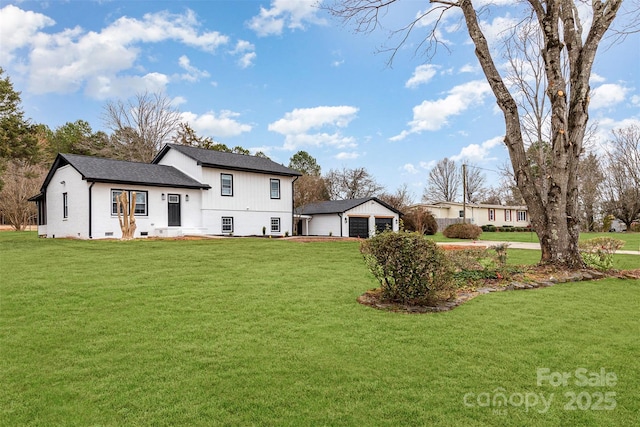 back of house with an outbuilding and a yard