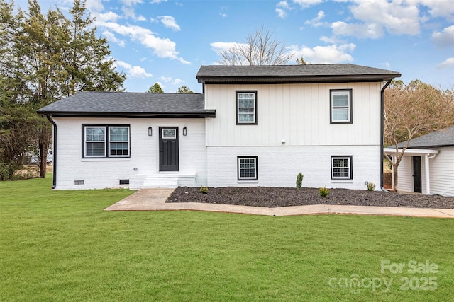 tri-level home with roof with shingles, brick siding, crawl space, and a front yard