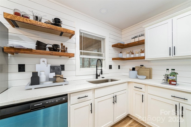 kitchen with open shelves, light wood-style floors, white cabinets, a sink, and dishwashing machine