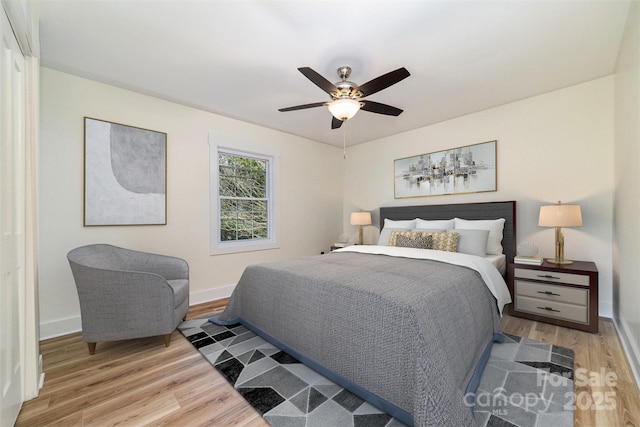 bedroom featuring ceiling fan, wood finished floors, and baseboards