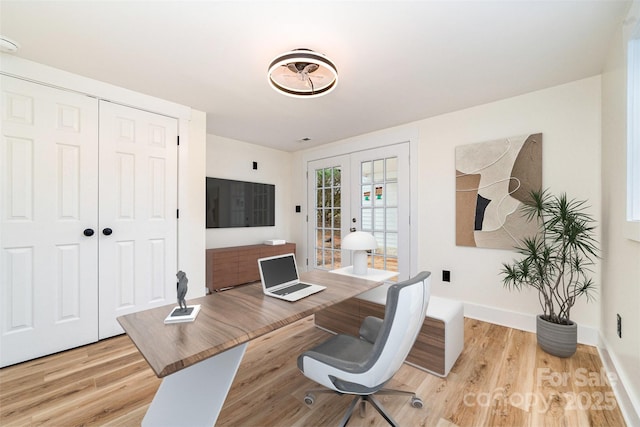 office area with light wood-type flooring, french doors, and baseboards