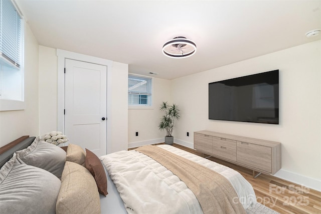 bedroom featuring light wood-type flooring and baseboards