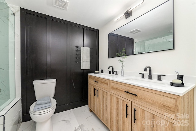 bathroom with toilet, marble finish floor, visible vents, and a sink