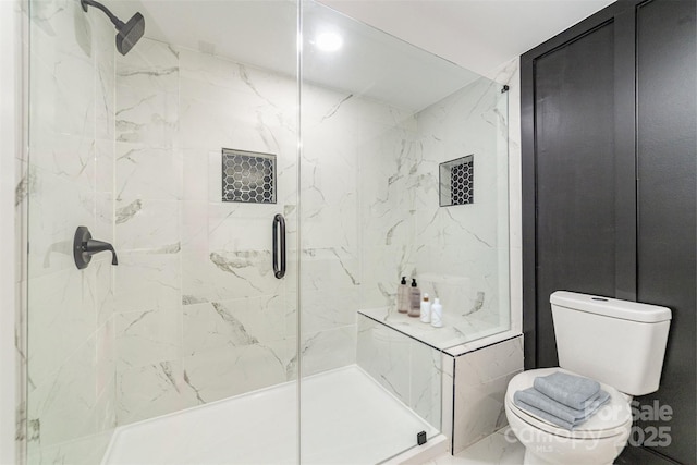 full bath featuring a marble finish shower and toilet