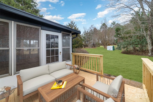 wooden terrace featuring an outdoor living space and a yard