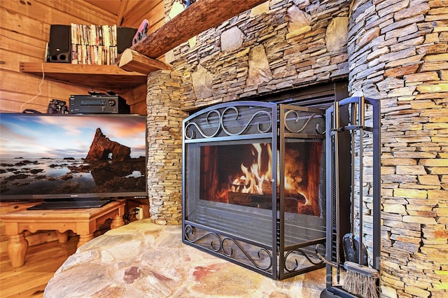 room details with a fireplace, wood finished floors, and a gate